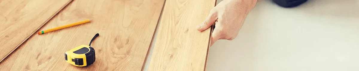 A professional installing wood flooring in Atlanta, GA