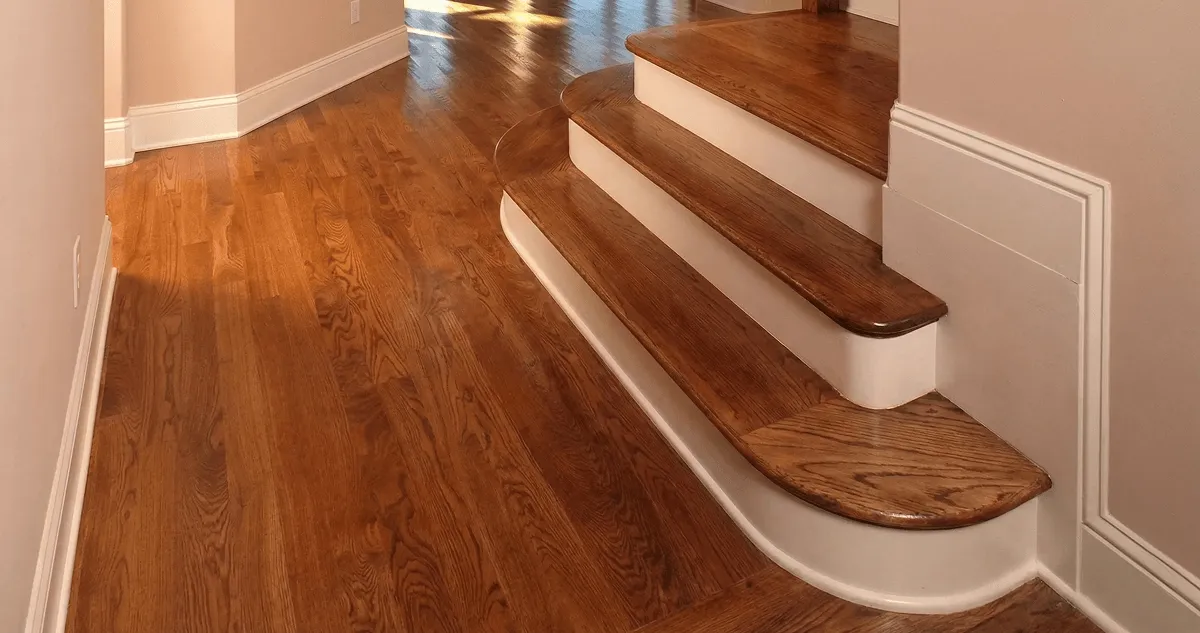 Base floor of a staircase with professionally restored wood flooring in Atlanta GA