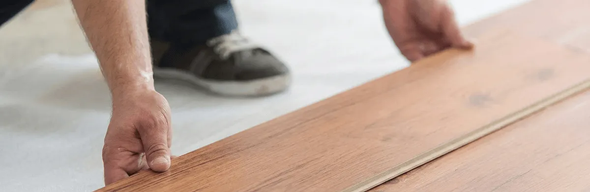 A professional installing laminate flooring in Atlanta, GA
